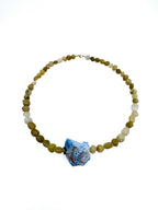 lapisatelier.com handcrafted beaded necklace with a raw blue stone pendant and olive-green jade-toned beads